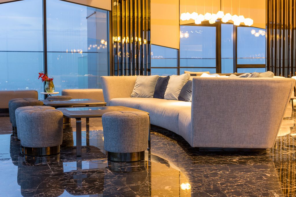 Luxury lounge in modern hotel featuring modern sofa and marble floor.